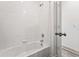 Bright bathroom featuring a tub with white tile surround and a modern shower head at 3401 N Denali St, Aurora, CO 80019