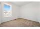 Simple bedroom showcasing neutral carpet, a window for natural light, and clean white walls at 3401 N Denali St, Aurora, CO 80019