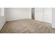 A carpeted bedroom is adjacent to the bathroom with glass shower at 3401 N Denali St, Aurora, CO 80019
