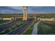 Community entrance featuring stone architecture, a clock tower, and lush landscaping at 3401 N Denali St, Aurora, CO 80019