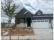Charming home featuring stone accents, a two-car garage, and a well-maintained front yard at 3401 N Denali St, Aurora, CO 80019