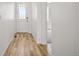 Well-lit hallway features wood-look flooring and neutral walls, providing a clean and inviting entry at 3401 N Denali St, Aurora, CO 80019