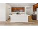 Kitchen island with seating, undermount sink, dark cabinets, and light countertops offering style and functionality at 3401 N Denali St, Aurora, CO 80019