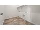 Laundry room with tiled floors, white walls, and built-in shelves and connections at 3401 N Denali St, Aurora, CO 80019