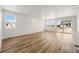 Spacious living room with wood-look flooring, large windows, and sliding glass doors offer natural light at 3401 N Denali St, Aurora, CO 80019