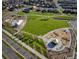 Aerial view of community park with playground, green space, and walking paths at 3401 N Denali St, Aurora, CO 80019