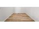 Spacious room displaying wood-look floors, white baseboards, and neutral wall paint at 3401 N Denali St, Aurora, CO 80019