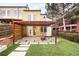 Relaxing backyard with artificial turf, concrete pavers, pergola, and privacy fencing, ideal for outdoor entertaining at 3221 Perry St, Denver, CO 80212