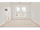 Bright bedroom with carpeted floors, neutral walls, and two windows providing natural light at 3221 Perry St, Denver, CO 80212