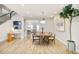 Bright dining area featuring hardwood floors, modern lighting, and a wooden dining table at 3221 Perry St, Denver, CO 80212