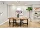 Dining room with hardwood floors, stylish lighting, and a large painting enhancing the space at 3221 Perry St, Denver, CO 80212