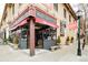 Corner view of Mondo Vino wine shop in brick building with red awnings and Highland Square signage at 3221 Perry St, Denver, CO 80212