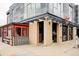 Street-level view of building 3300 with brick and metal exterior, outdoor patio, and neighborhood business at 3221 Perry St, Denver, CO 80212