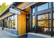 Street view of Blue Pan Detroit Style Pizza building with wooden and black accents, and reflective glass windows at 3221 Perry St, Denver, CO 80212