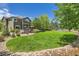 Well-manicured backyard featuring a hot tub, deck, and lush lawn, great for outdoor living at 14118 Whitney Cir, Broomfield, CO 80023