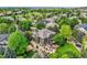 Aerial view of a beautifully landscaped backyard with a hot tub, deck, and mature trees, perfect for outdoor relaxation at 14118 Whitney Cir, Broomfield, CO 80023