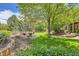 Spacious backyard with lush green grass, mature trees, a firepit, a pond and garden at 14118 Whitney Cir, Broomfield, CO 80023