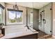 Modern bathroom featuring a soaking tub, a tiled shower, and a large window with natural light at 14118 Whitney Cir, Broomfield, CO 80023