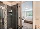 Bathroom revealing tiled shower and bedroom space with bed and window at 14118 Whitney Cir, Broomfield, CO 80023