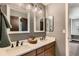 Bathroom featuring dual sinks with stylish hardware, framed mirrors and modern lighting fixtures at 14118 Whitney Cir, Broomfield, CO 80023