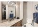 Bathroom features granite countertop, sink, and toilet with patterned towels at 14118 Whitney Cir, Broomfield, CO 80023