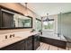 Bright bathroom with double vanity, large mirror, soaking tub, and subway tile at 14118 Whitney Cir, Broomfield, CO 80023
