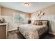 Bedroom features charming white wood-look wainscoting, neutral walls and carpet, and a large window at 14118 Whitney Cir, Broomfield, CO 80023