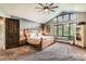 Comfortable main bedroom featuring a large window, patterned wallpaper, and a wooden accent wall at 14118 Whitney Cir, Broomfield, CO 80023
