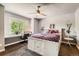 Bright bedroom features a ceiling fan, large window with a desk and a white bedframe at 14118 Whitney Cir, Broomfield, CO 80023