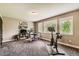 Bonus room showcasing natural light, neutral paint, carpet and a exercise bike at 14118 Whitney Cir, Broomfield, CO 80023