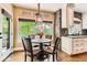 Bright breakfast nook with large windows overlooking lush greenery and deck at 14118 Whitney Cir, Broomfield, CO 80023