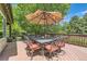 Wooden deck area with dining table and umbrella, perfect for outdoor dining and relaxation at 14118 Whitney Cir, Broomfield, CO 80023