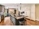 Beautiful kitchen featuring a large island with seating, hardwood floors, and stainless appliances at 14118 Whitney Cir, Broomfield, CO 80023