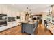 Spacious kitchen with a large center island, modern appliances, and hardwood floors at 14118 Whitney Cir, Broomfield, CO 80023