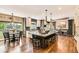 Open concept kitchen with a large island, seating, and hardwood floors at 14118 Whitney Cir, Broomfield, CO 80023