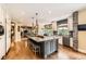 Well-equipped kitchen featuring a large island with seating, hardwood floors, and stainless appliances at 14118 Whitney Cir, Broomfield, CO 80023