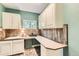 Well-organized laundry room with ample counter space, a sink, and plenty of storage cabinets at 14118 Whitney Cir, Broomfield, CO 80023