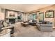 Cozy living room with a stone fireplace, comfortable seating, and natural light at 14118 Whitney Cir, Broomfield, CO 80023