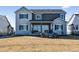 Backyard view of a two-story home with a patio and fire pit seating area at 16075 E 109Th Pl, Commerce City, CO 80022