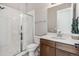 Modern bathroom with glass-enclosed shower, white tile, and a spacious vanity at 16075 E 109Th Pl, Commerce City, CO 80022