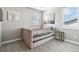 Cozy bedroom with a daybed, soft gray carpet, and natural light streaming through the windows at 16075 E 109Th Pl, Commerce City, CO 80022