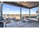 Inviting covered patio features a porch swing and fire pit with seating, perfect for outdoor relaxation and entertaining at 16075 E 109Th Pl, Commerce City, CO 80022