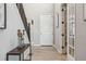 Charming entryway with wood-look flooring, a staircase, and a decorative table and french doors at 16075 E 109Th Pl, Commerce City, CO 80022