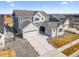 Stunning two-story home showcasing a three-car garage and a well-manicured front yard, offering curb appeal at 16075 E 109Th Pl, Commerce City, CO 80022