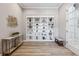 Hallway featuring built-in shelving, decorative elements, and wood-look flooring at 16075 E 109Th Pl, Commerce City, CO 80022