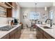 Modern kitchen featuring stainless steel appliances, gas range, and a dining area with a chandelier at 16075 E 109Th Pl, Commerce City, CO 80022