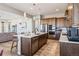 Kitchen featuring an island with sink, stainless steel appliances, and modern fixtures with a gas range at 16075 E 109Th Pl, Commerce City, CO 80022