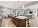 Open-concept kitchen with a large island, stainless steel appliances, and a view into the living room at 16075 E 109Th Pl, Commerce City, CO 80022