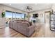 Cozy living room featuring a sectional sofa, fireplace, and large sliding doors to the patio at 16075 E 109Th Pl, Commerce City, CO 80022