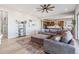 Open living area featuring a spacious sectional, built-in shelving, and seamless flow to the kitchen at 16075 E 109Th Pl, Commerce City, CO 80022